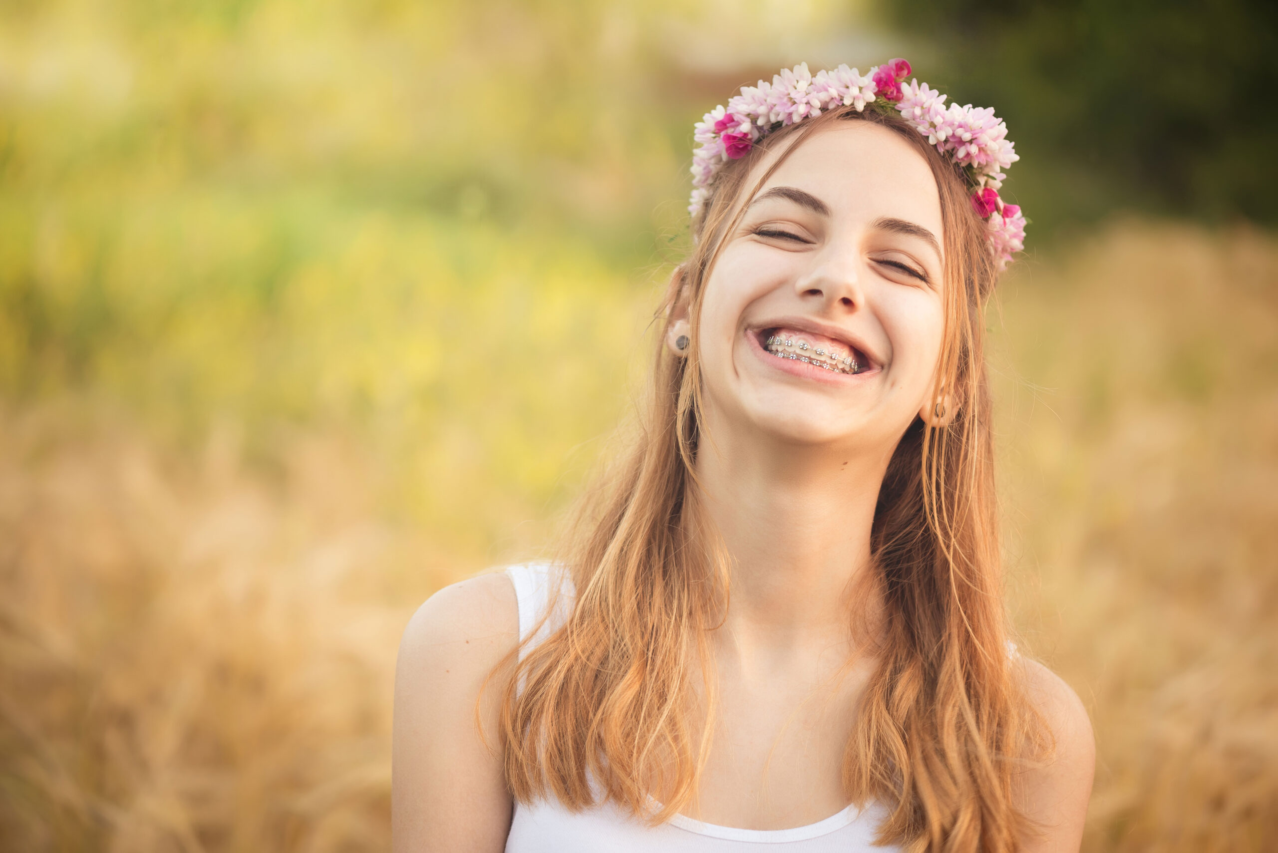 Young teen with braces smiling during summer vacation